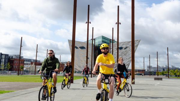 Group of people enjoying a bike tour around Titanic Quarter Belfast.