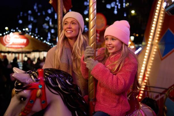 Mother and daughter on the carousel at the Christmas Market