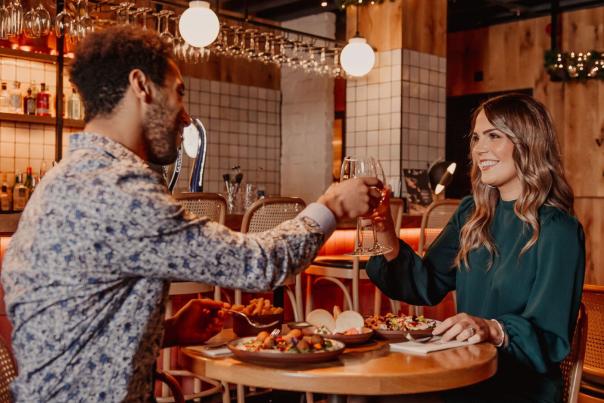 A couple enjoying dinner and drinks at Crafty Vintner.