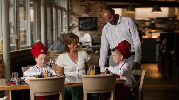 Two kids enjoying the Little Boars menu at Fratelli which includes making their own pizzas.