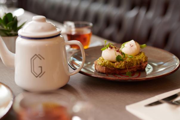 Plate of food at the Grand Central Hotel with a pot of tea.