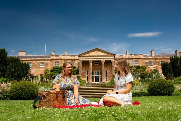 Two women enjoying a picnic at Hillsborough Castle and Gardens