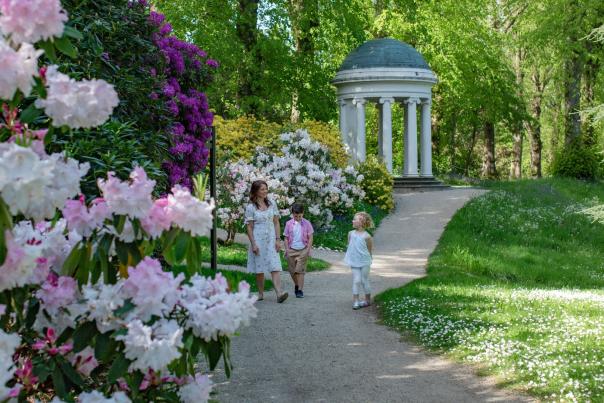 Mum and two kids walking through the gardens at Hillsborough Castle