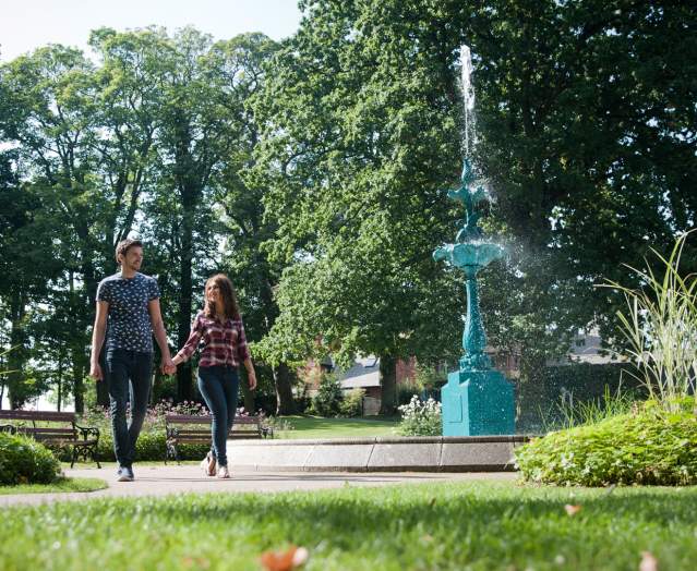 couple walking in Lisburn-Castle-Gardens