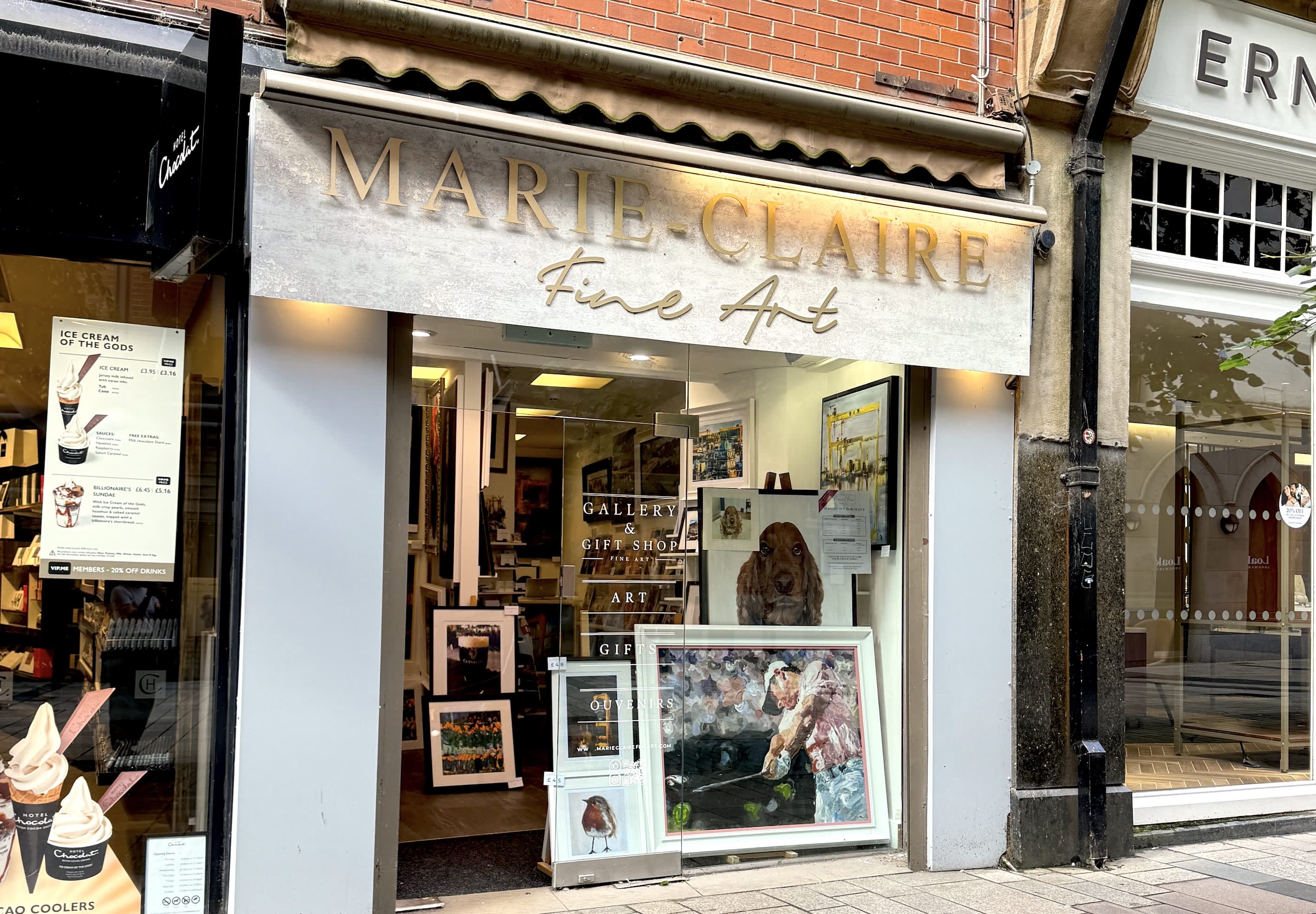 A photo of Marie-Claire Fine Art shop in Belfast city centre, the photo shows a shop with art sitting in the window.