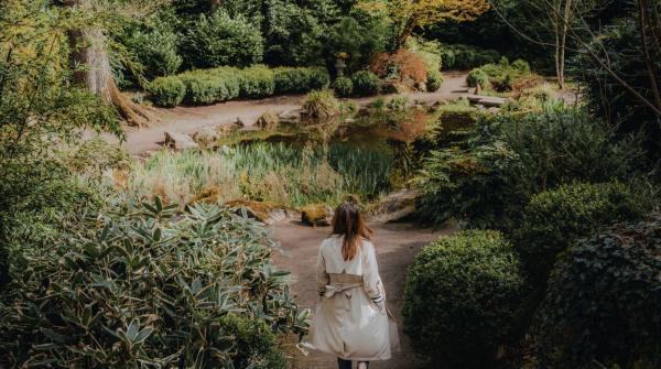 Woman walking through Lady Dixon Park at the pond