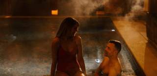 Couple in an outdoor swimming pool in winter