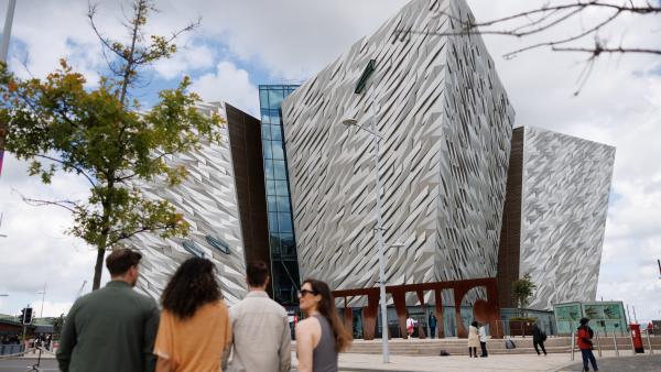 Group of 4 people walking towards Titanic Belfast
