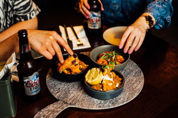 People sharing food at Sweet Afton in Belfast.
