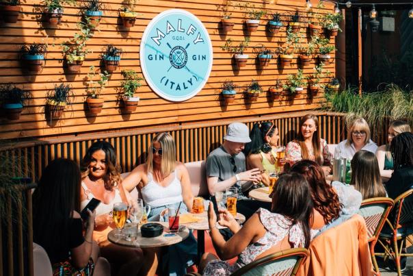 Group of people enjoying a drink in Tetto's beer garden.