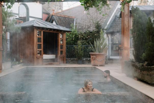 Couple in pool at Old Inn's Treetop Spa